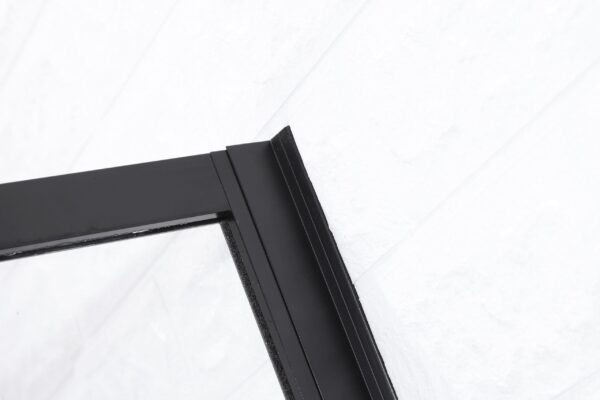 Close-up van de bovenkant van een zwarte douchedeur met een metalen frame